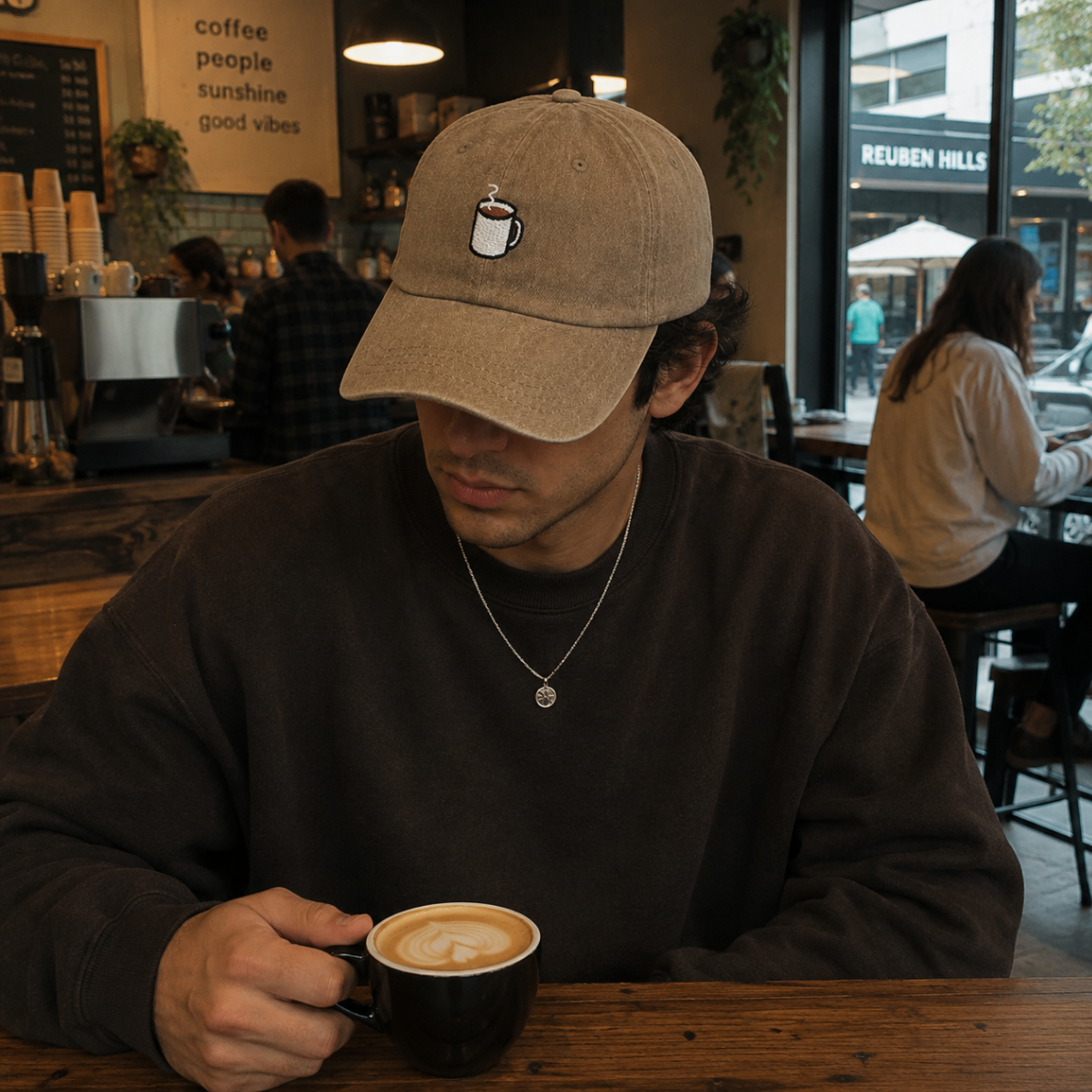 Model wearing a coffee-colored dad hat inside a cafe