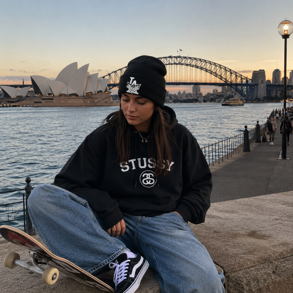 Model wearing a black beanie by Sydney Harbour at dusk